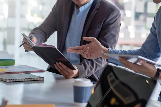 businessman come up with work ideas using tablet and taking notes at the office