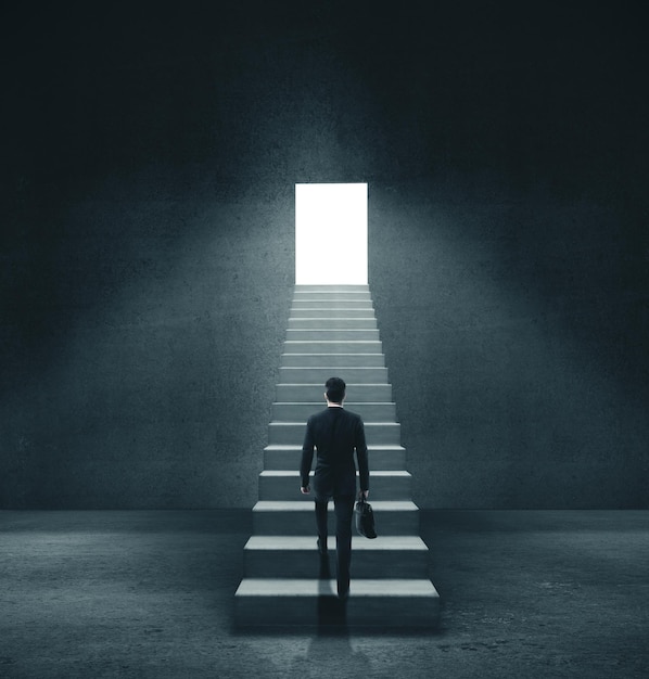 Businessman in concrete room walking to open door