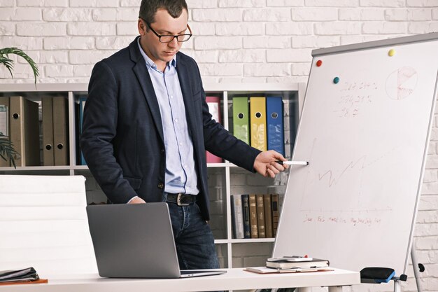 Businessman conducts presentation online having video conference serious man wearing glasses and jac