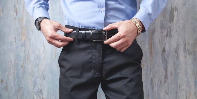 Businessman correcting his belt.