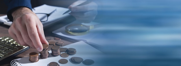 Businessman counting coins on the desk