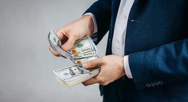 Businessman counting dollar bills