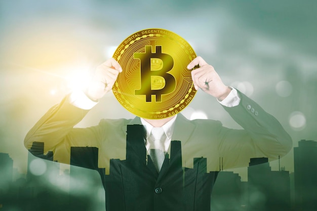 Businessman covering his face with bitcoin symbol