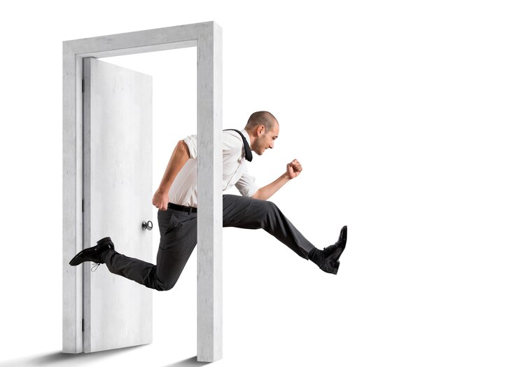 Businessman crosses a door. Concept of renewal