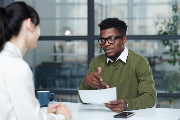 Businessman discussing resume with candidate