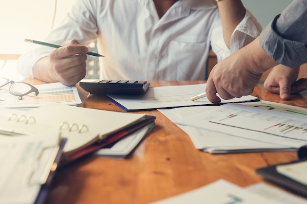 Businessman discussing sale analysis chart with his partner.