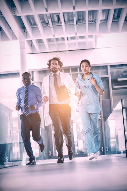 Businessman and doctor in hospital corridor