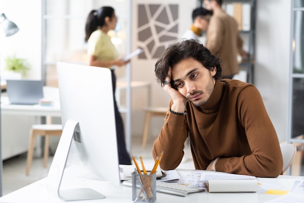 Businessman doing boring job at office