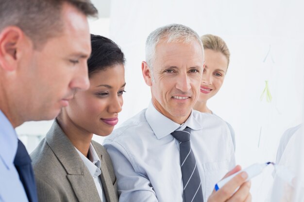 Businessman drawing graph on the board