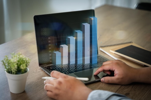 A businessman draws a growth graph showing the success of business Business strategy development and growing successful business concepts