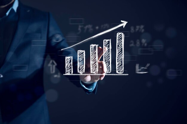 Photo businessman draws an increasing trend arrow and a rising chart