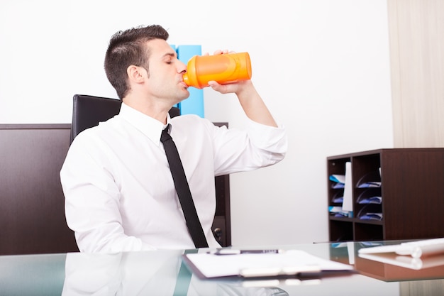 Businessman drink a protein shake