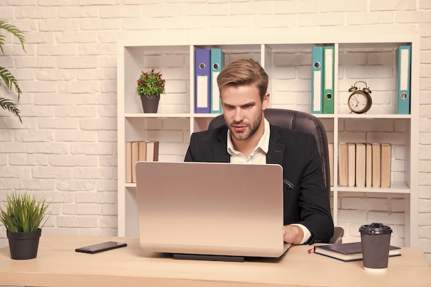 Businessman drinking coffee Confident man use laptop Handsome man in business office Inspired with cup of fresh coffee Ceo head office concept Business development Starting own business