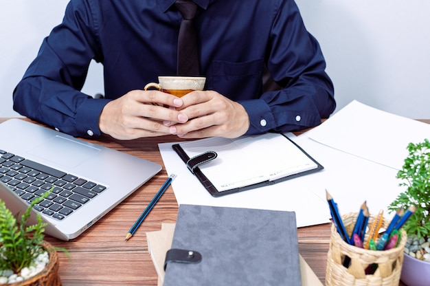 Businessman drinking coffee at his desk