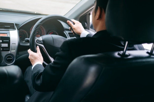 Businessman driving a car.