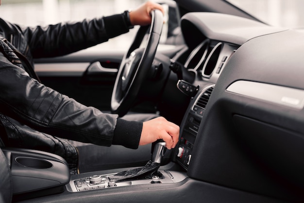 Businessman driving luxury modern car in the city