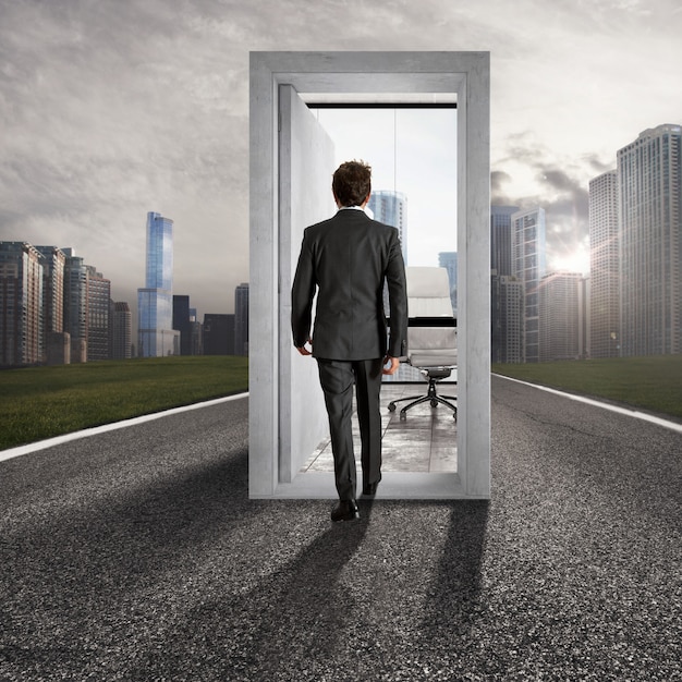 Photo businessman entering an open door in the center of a road leading to career success