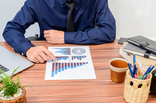 Businessman examines the documents at the desk in the room