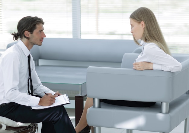 Businessman examining a working papersitting in the office