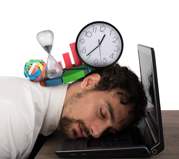 Businessman exhausted from business crisis sleeping over computer