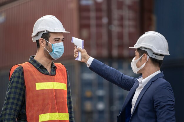 Businessman and factory worker wearing medical masks