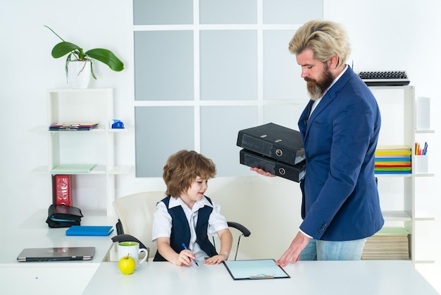 Businessman father with his son drawing on business papers at office marketing team meeting brainsto