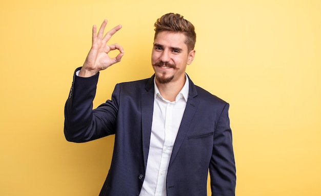 Businessman feeling happy, showing approval with okay gesture