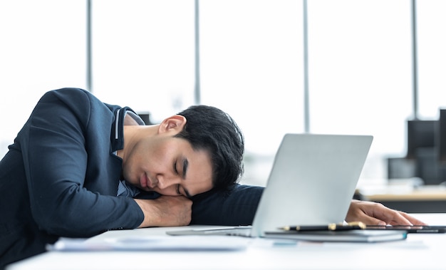 businessman fell asleep on laptop computer