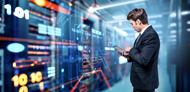 Businessman finger touch phone standing in data center server room Powerful computers with glowing hud hologram of digital analysis and circuit lines Concept of IT and engineering