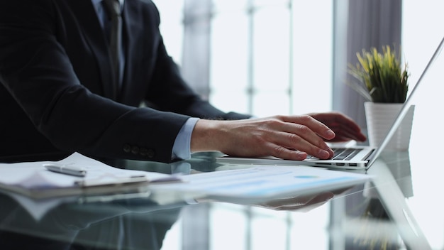 Businessman finger typing on computer keyboard in office