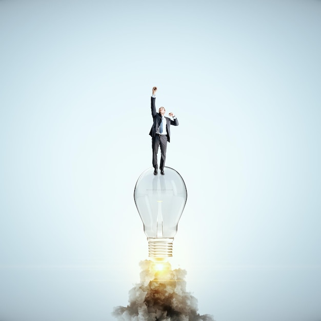 Businessman flying with launching lamp