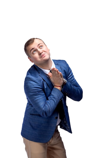 Businessman folded hands in prayer gesture begging about something while looking up