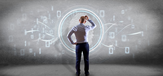 Businessman in front of a Digital fingerprint identification and binary code 