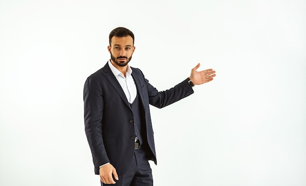 The businessman gesturing on the white wall background