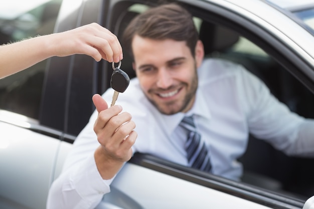 Businessman getting his new car key