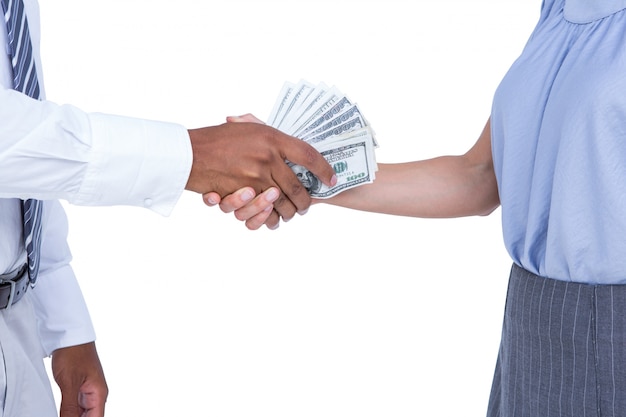 Businessman giving bank notes to his colleague