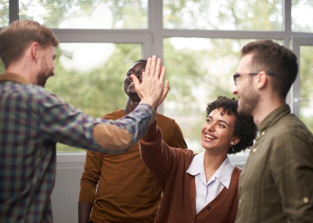 Businessman giving high five to his partner in office