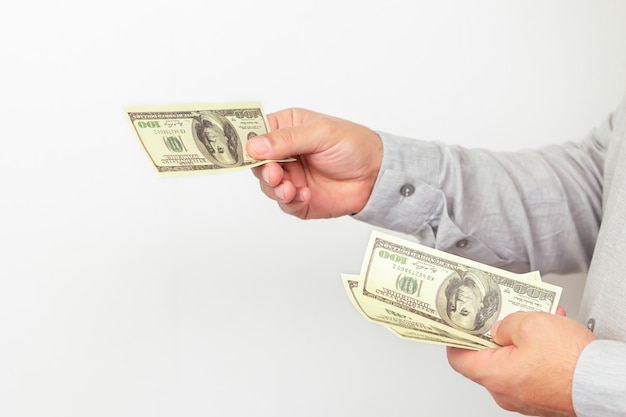 Businessman giving money us dollar bills close-up