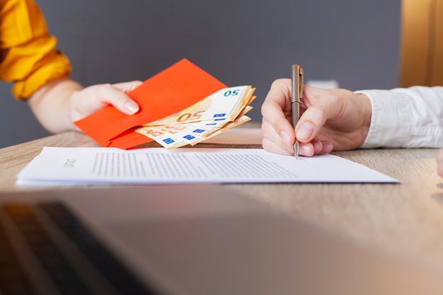 Businessman giving money while making deal to agreement a real estate contract and financial corporate