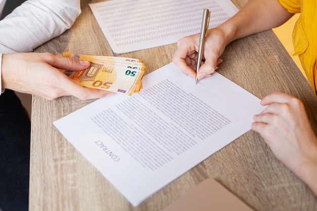 Businessman giving money while making deal to agreement a real estate contract and financial corporate