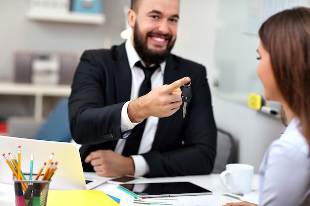 businessman giving out car keys