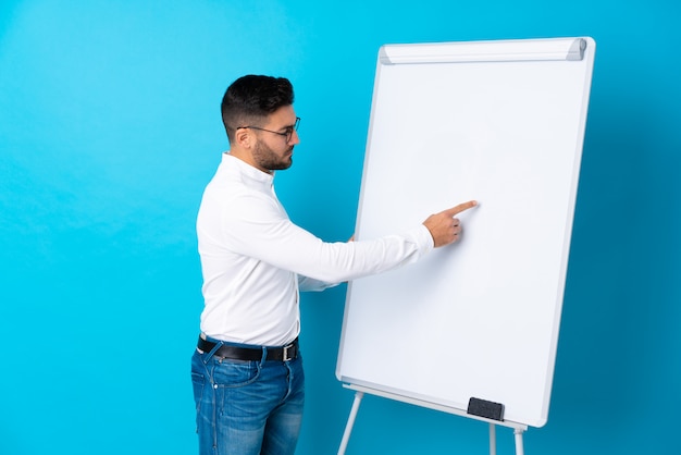 Businessman giving a presentation on white board giving a presentation on white board