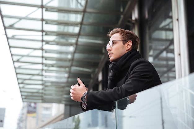 Businessman in glasses near the office.