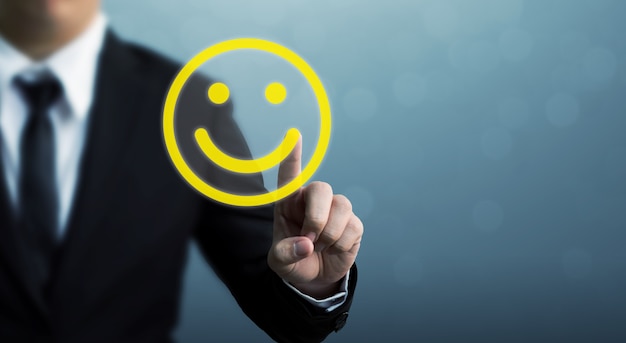 Businessman hand drawing smiley face