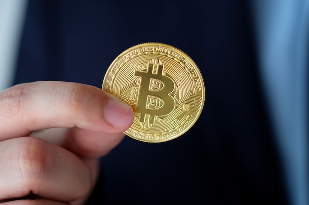 Businessman hand holding bitcoins