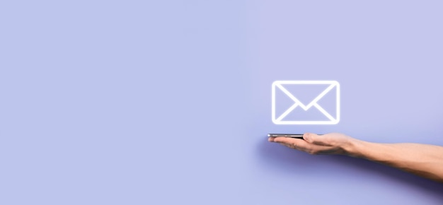 Businessman hand holding e-mail icon, contact us by newsletter email and protect your personal information from spam mail. customer service call center contact us concept