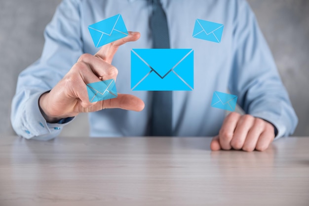 Businessman hand holding email icon Contact us by newsletter email and protect your personal information from spam mail Customer service call center contact us concept