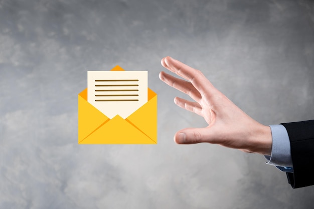 businessman hand holding email icon contact us by newsletter email and protect your personal information from spam mail customer service call center contact us concept
