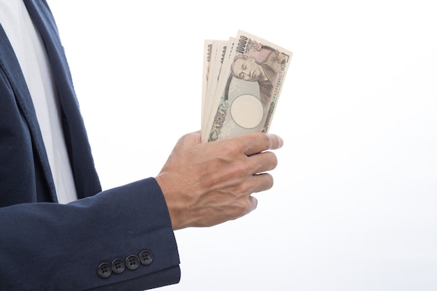 Businessman hand holding Japanese banknote