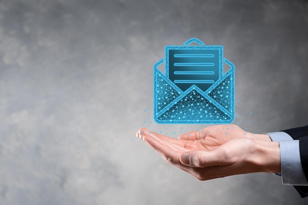 Businessman hand holding letter icon,email icons.Contact us by newsletter email and protect your personal information from spam mail.Customer service call center contact us.Email marketing newsletter.